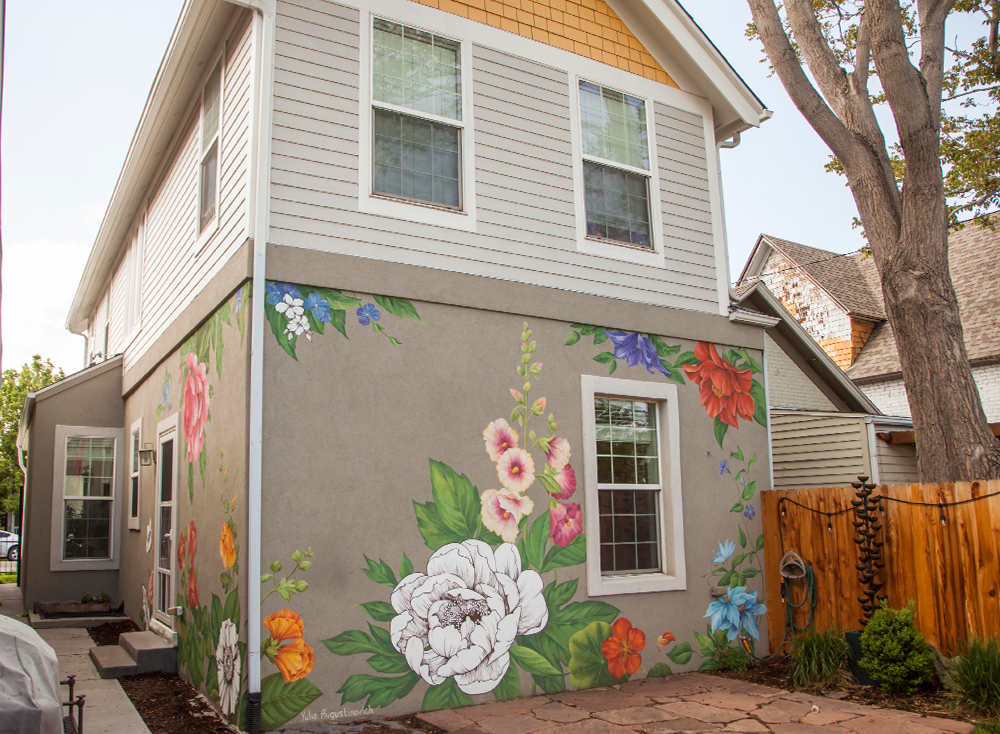 floral-exterior-house-mural-yulia-avgustinovich-denver-co Floral mural by Yulia Avgustinovich on the exterior of a private home in Denver, Colorado, combining realistic full-color flowers with black-and-white graphic line drawings.