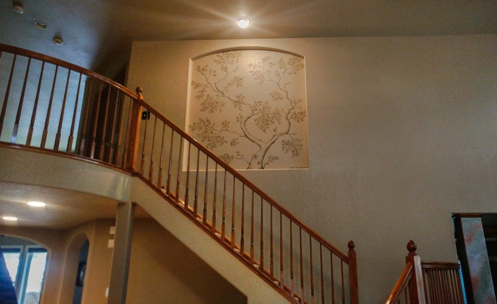 monochrome-tree-mural-golden-co-entryway-yulia-avgustinovich Monochrome tree mural above staircase in private residence entryway in Golden, Colorado