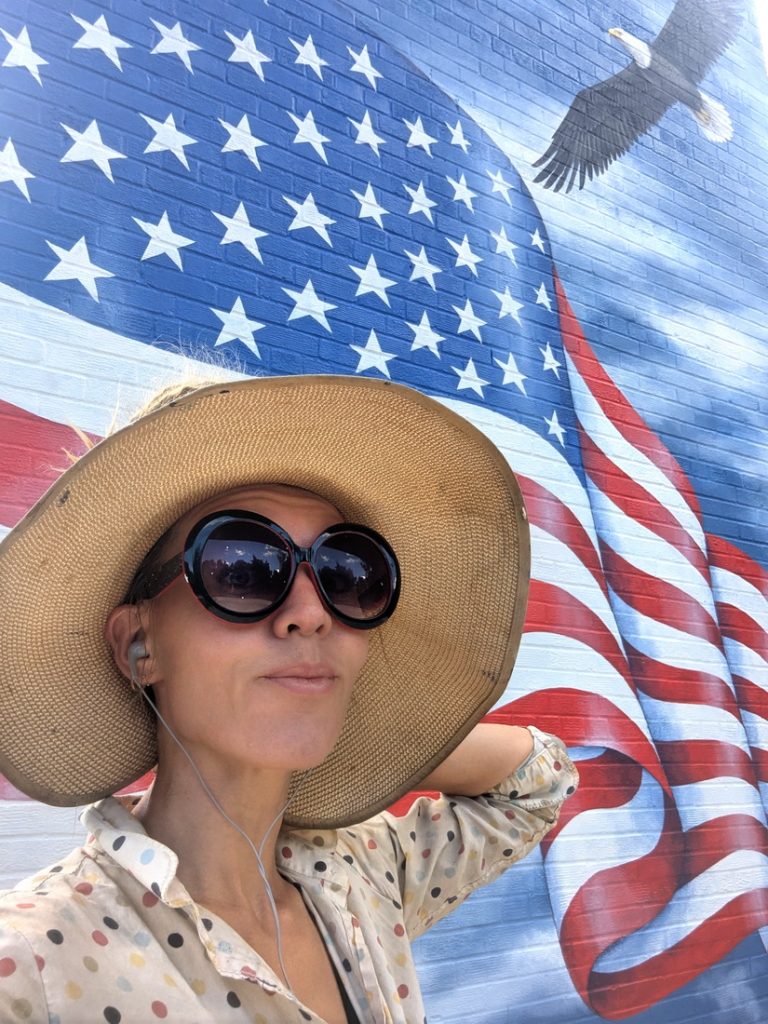 Artist Yulia Avgustinovich painting a public art mural on the Town Hall tower in Landover Hills, Maryland