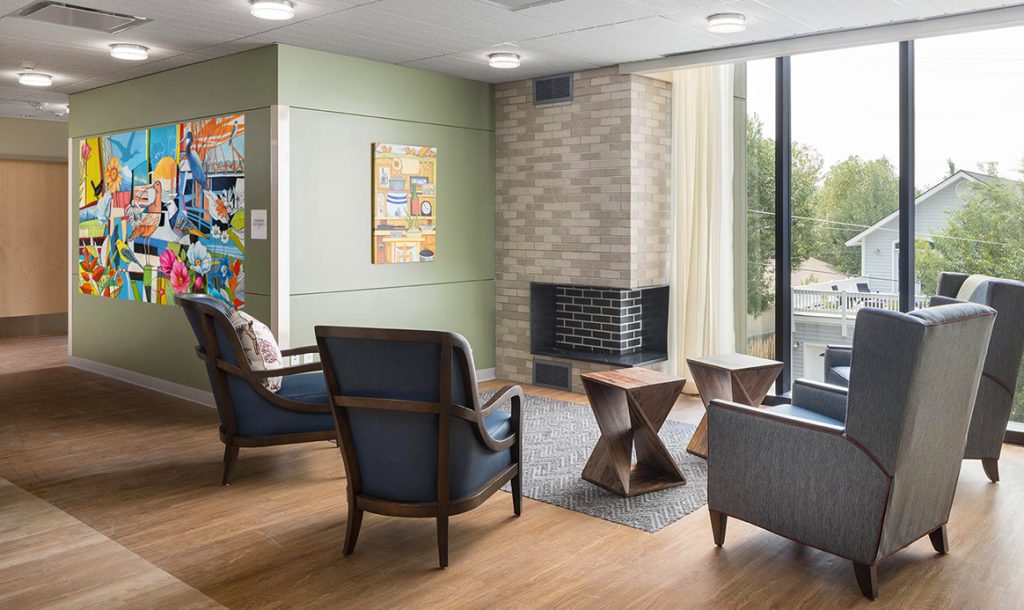 jackson-wyoming-nature-mural-senior-living-yulia-avgustinovich The view of Wonders of Nature mural in the common area of Sage Living, featuring mountain wildflowers and native birds.