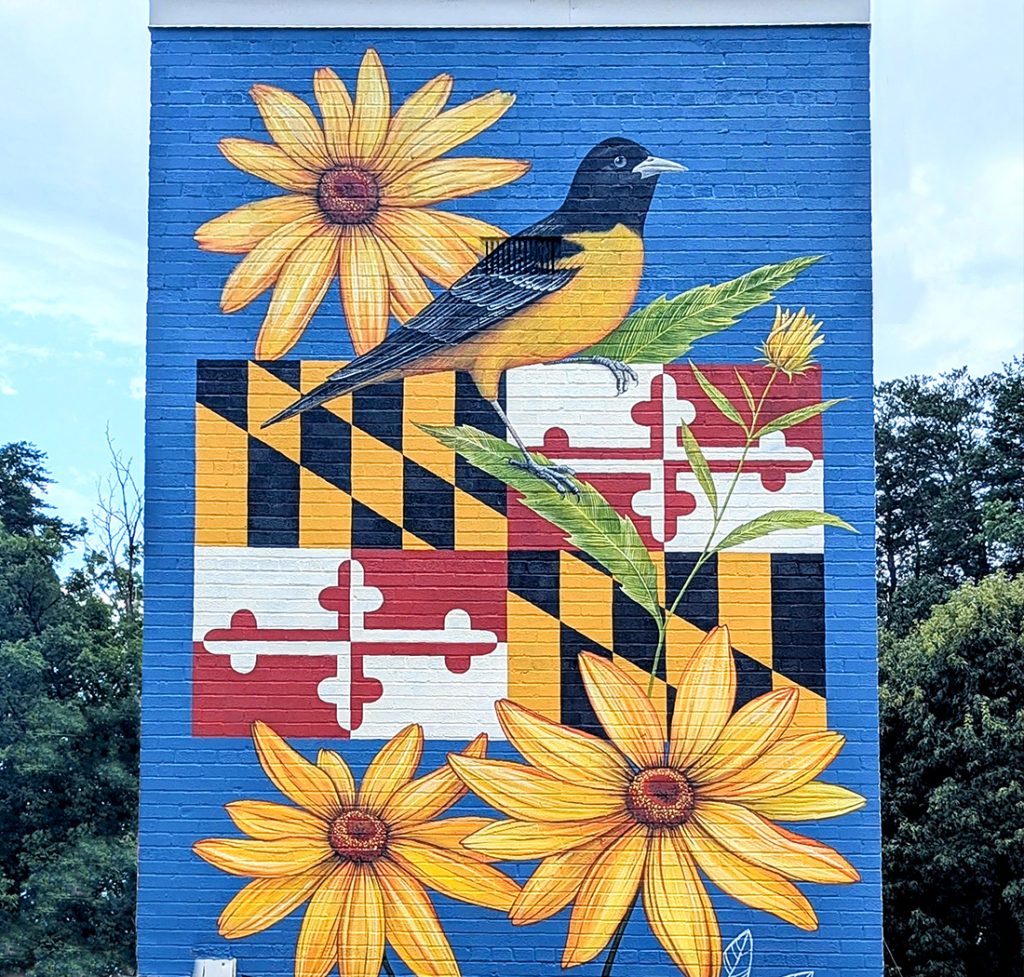 Symbolic public art mural on the Town Hall tower in Landover Hills, Maryland, featuring state symbols, the American flag with bald eagle, and the town seal