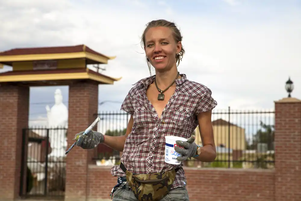 Community volunteers painting a large-scale street mural in Aurora, Colorado during a public art project.
